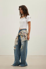 Newspaper graffiti logo print tie-detail blue ripped jeans