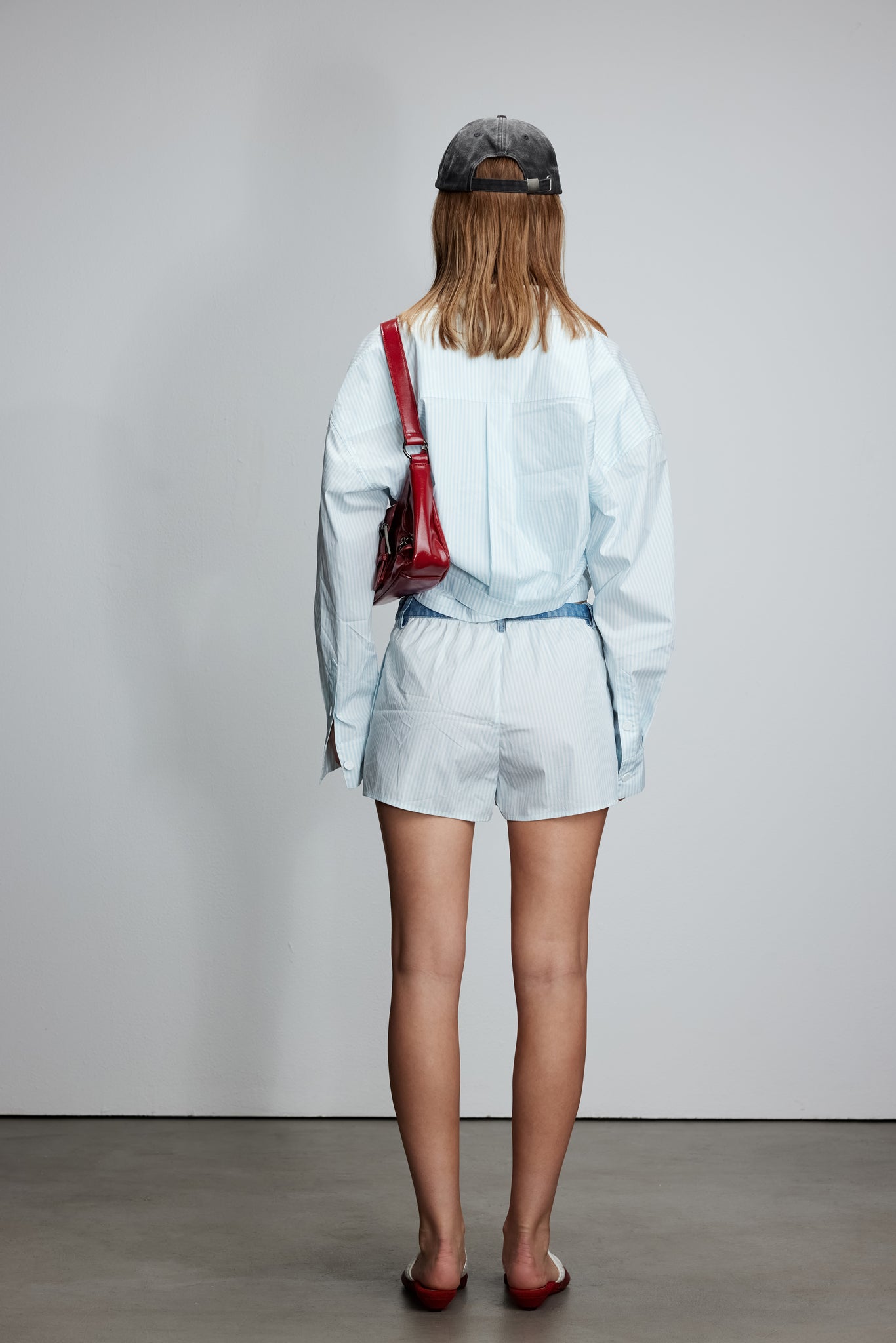 Two-piece striped tie-front shirt with denim patchwork pleated shorts