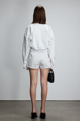 Two-piece striped tie-front shirt with denim patchwork pleated shorts