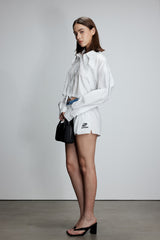 Two-piece striped tie-front shirt with denim patchwork pleated shorts